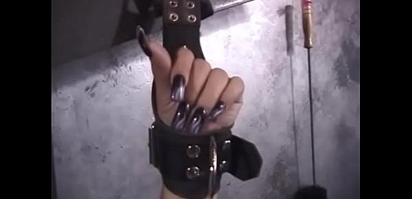  Ebony beauty in a latex suit hooks a bunch of clothespins on the cunt of a tied captive
